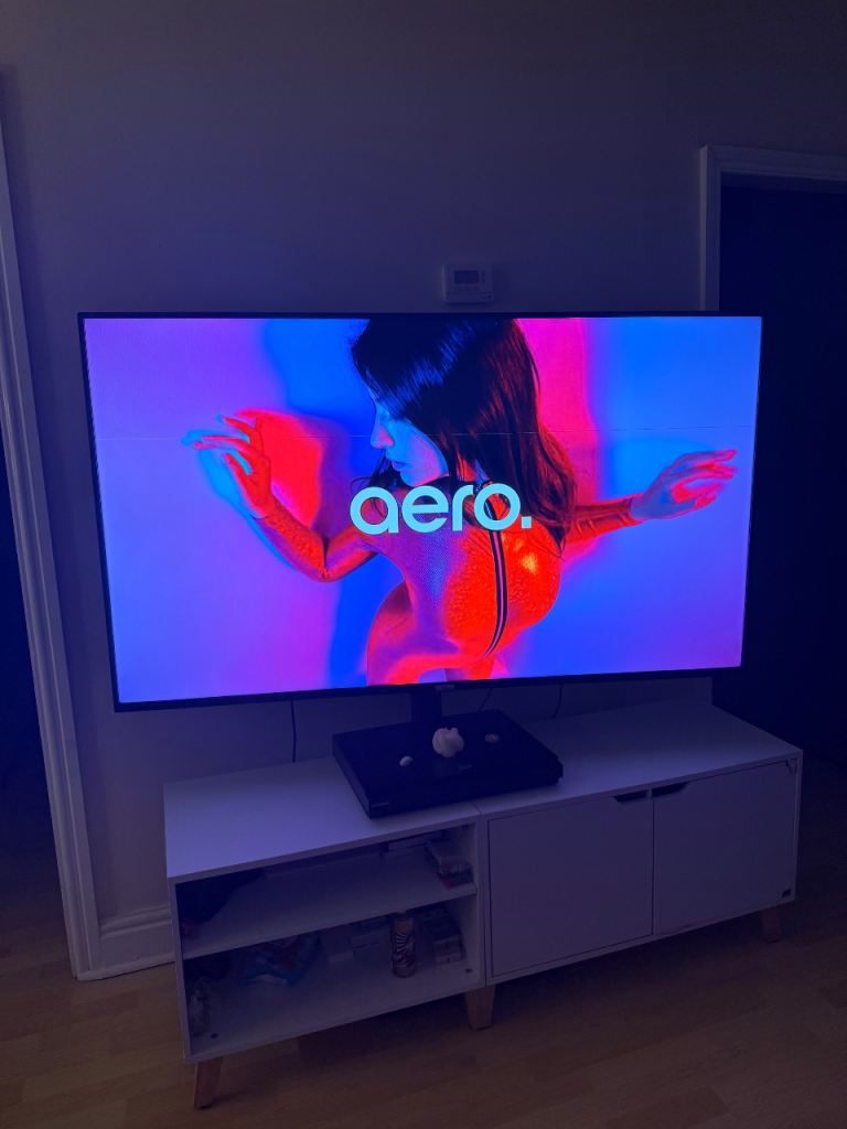 TCL 65” 4K Smart Android TV + Swivel Stand + White TV unit shown in the photos