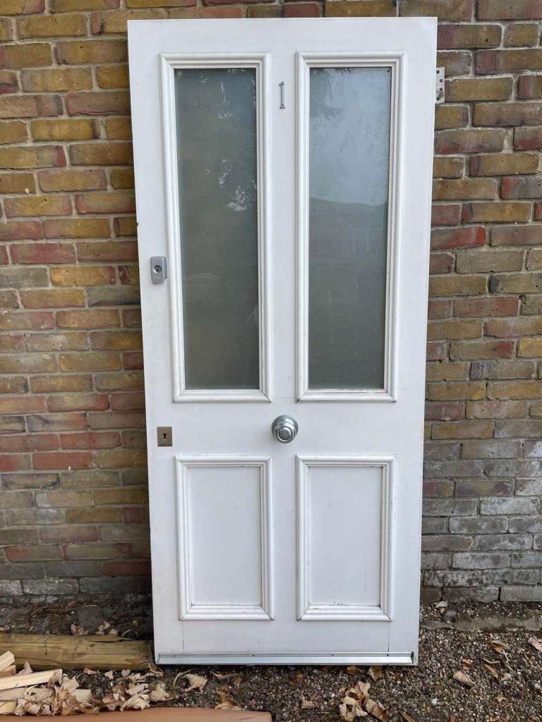 Double glazed front solid door white with locks, handle and hinges.