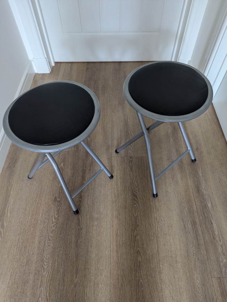 Two sturdy folding stools in good condition