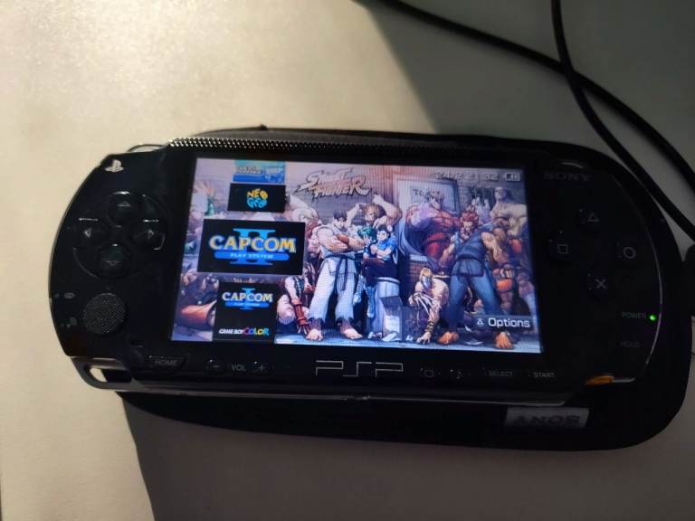 PSP 1003 with OSTENT battery, USB DATA cable & 64gb memory card.