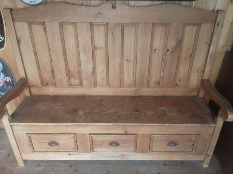 Wooden bench seat with drawer storage.