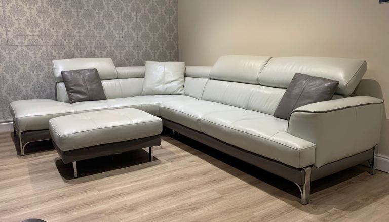 White and grey leather corner sofa and footrest