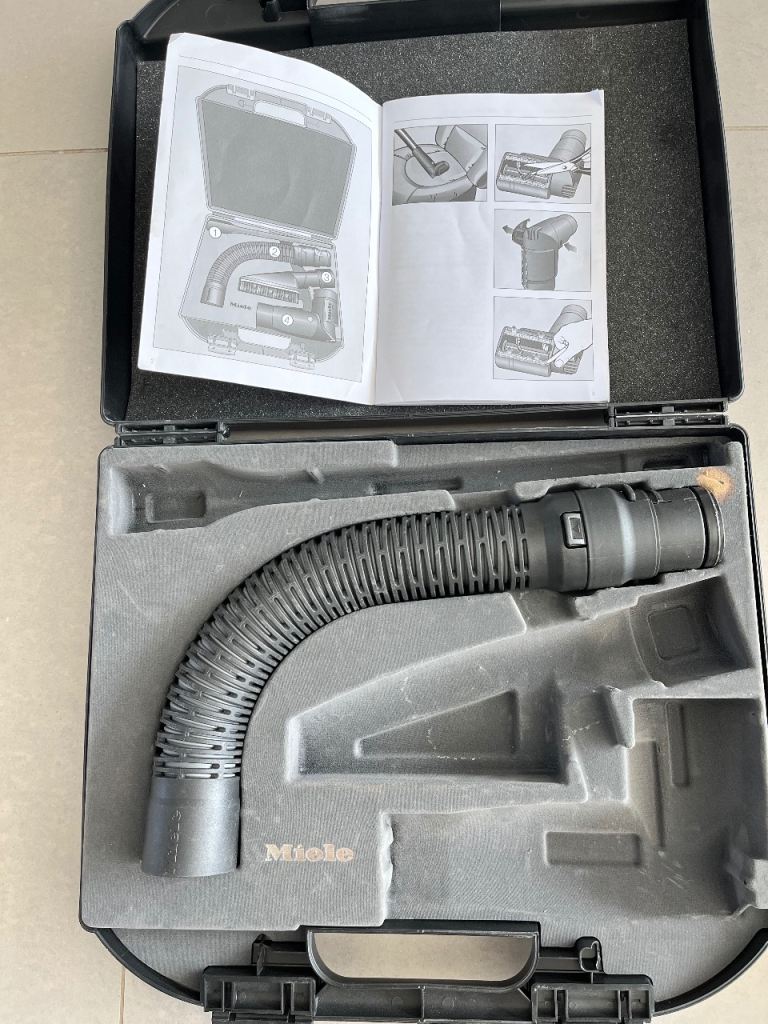 Miele car care case with flexible adapter hose.