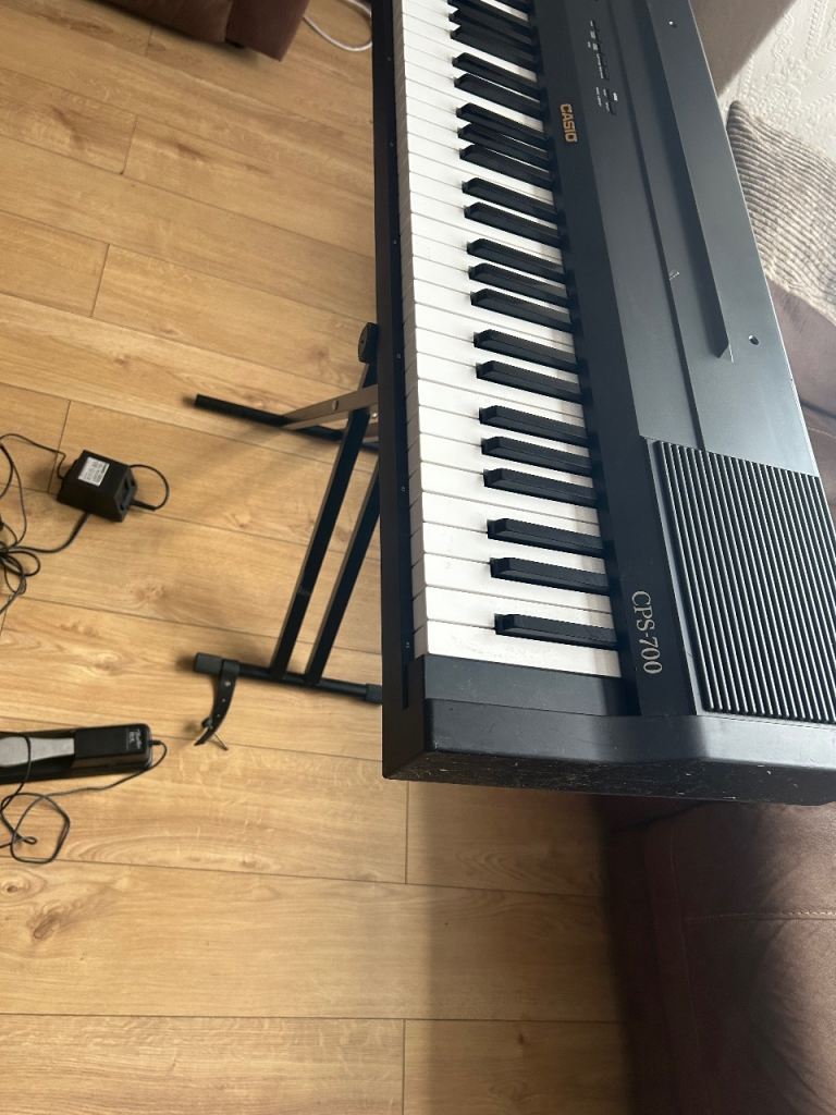 Casio electric keyboard piano with stand , power supply , and sustain foot pedal 