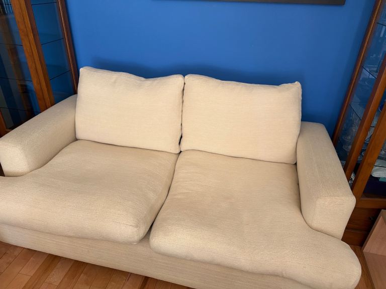 Cream Two-Seater Fabric Sofa – Good Condition