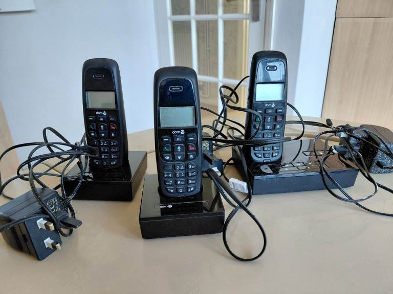 Answering phone with set of 3 cordless phones.