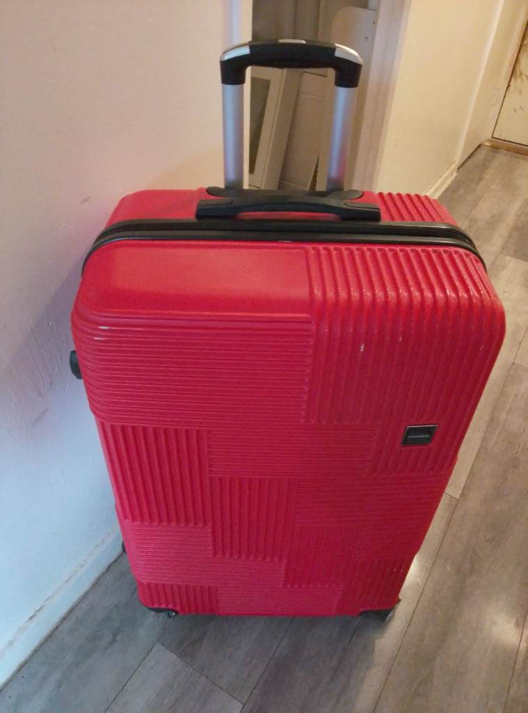 Red very large manoukian suitcase