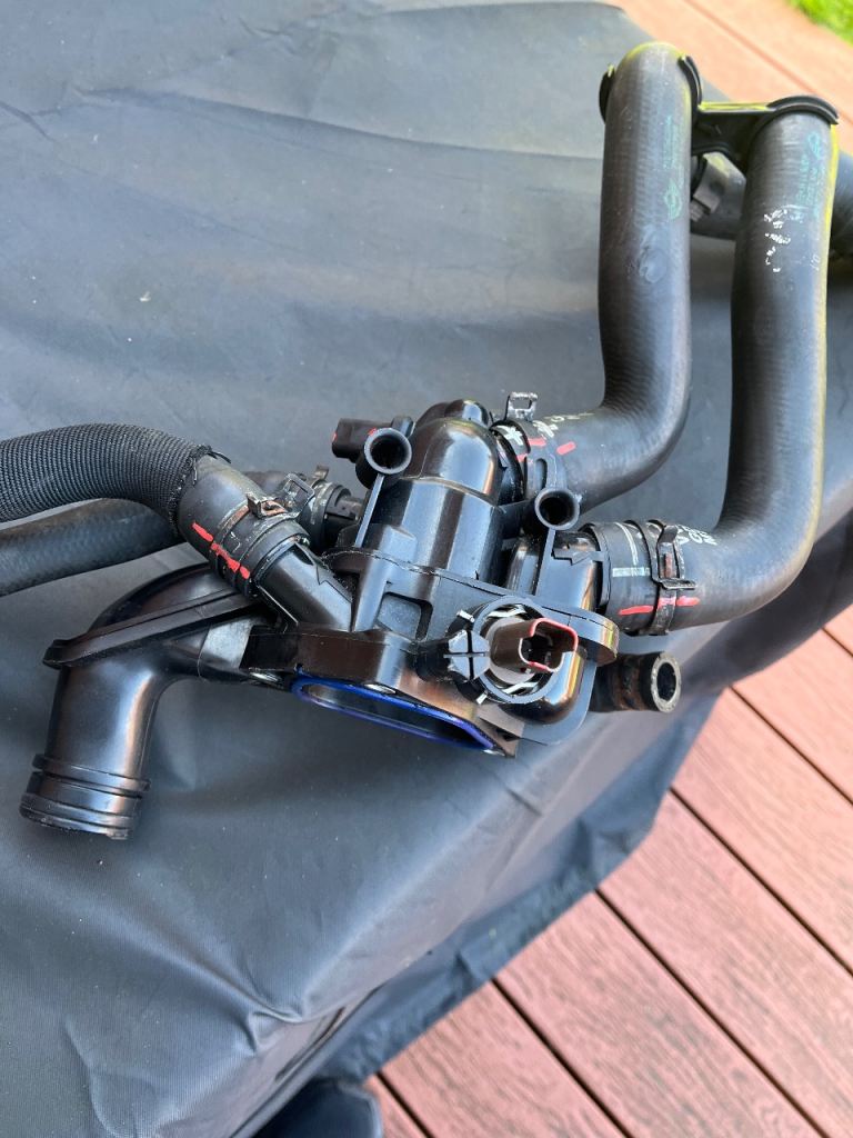 Mini Cooper S Thermostat housing with hoses.