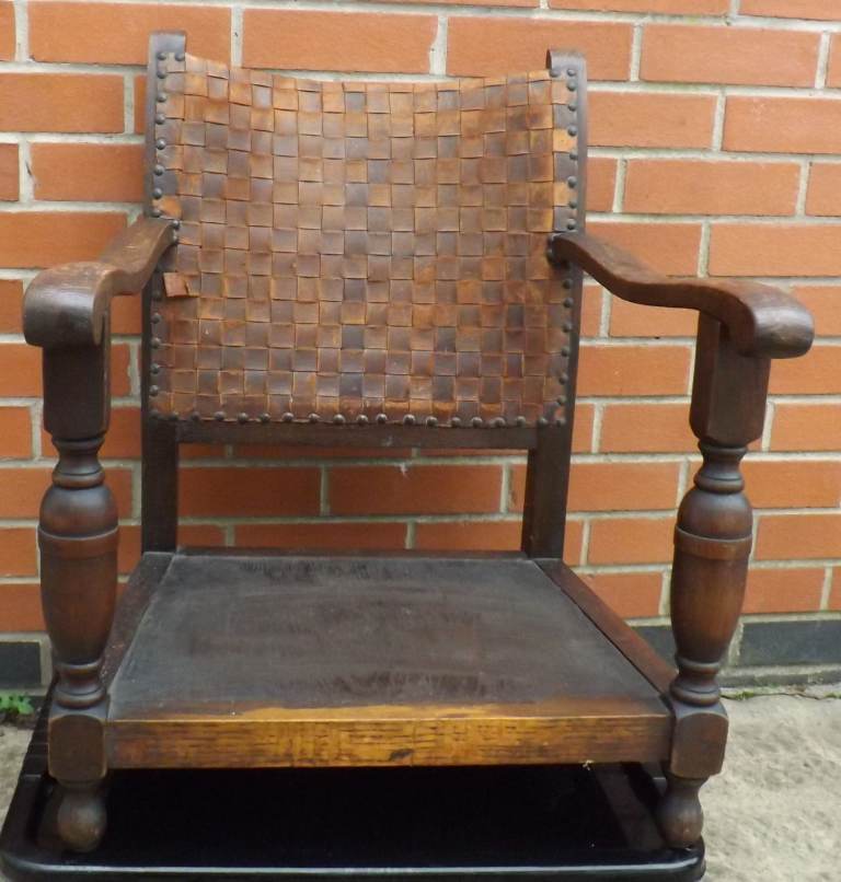 Leather woven back chair with no legs, would make an ideal dog bed for a small dog