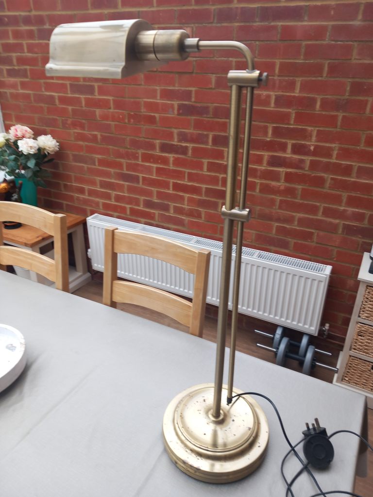 Adjustable brass floor lamp, often referred to as a banker's or task lamp