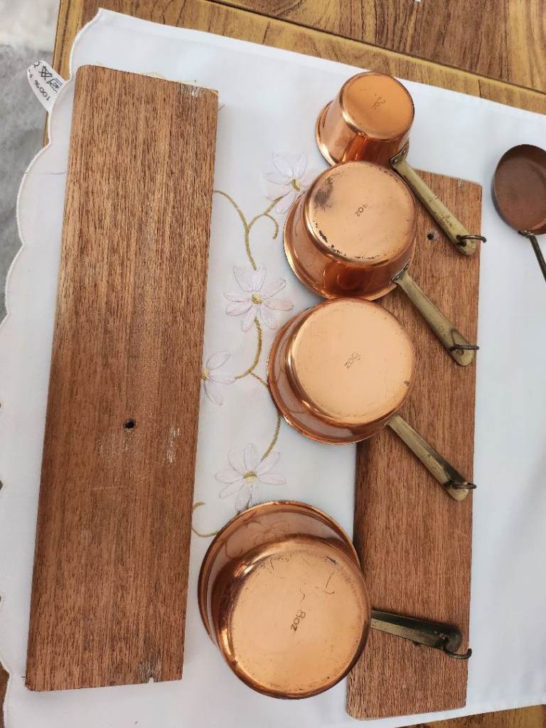 Two sets of measuring saute pots with racks with hooks 