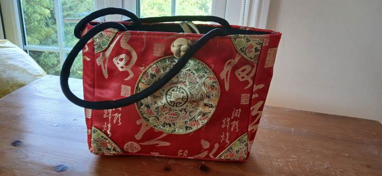 Red Embroidered Fabric Handbag with Black Handles – Good Condition