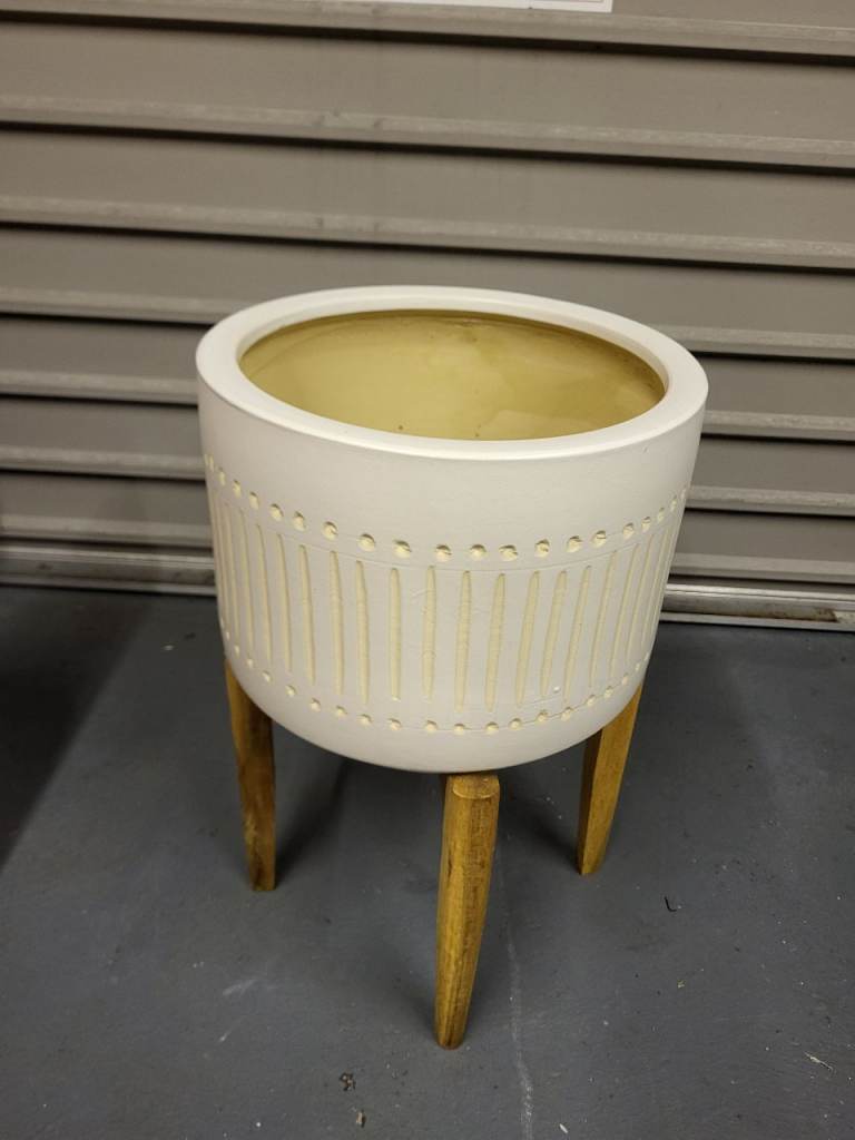 Plant pot on wooden stand 