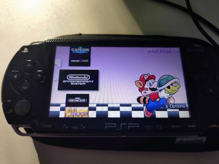 PSP 1003 with OSTENT battery, USB DATA cable & 64gb memory card.