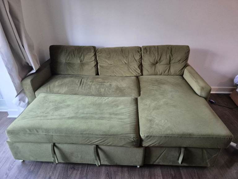 Green pull out sofa with storage