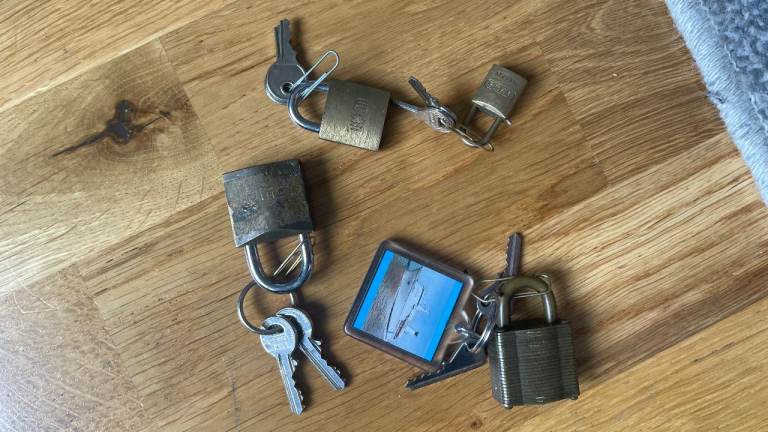 Four small padlocks, each with two keys