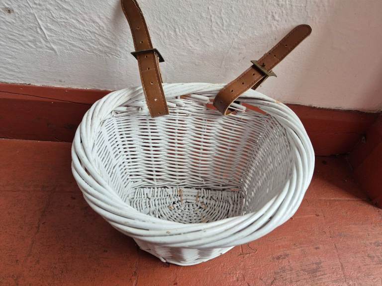 Girl's white wicker bike basket