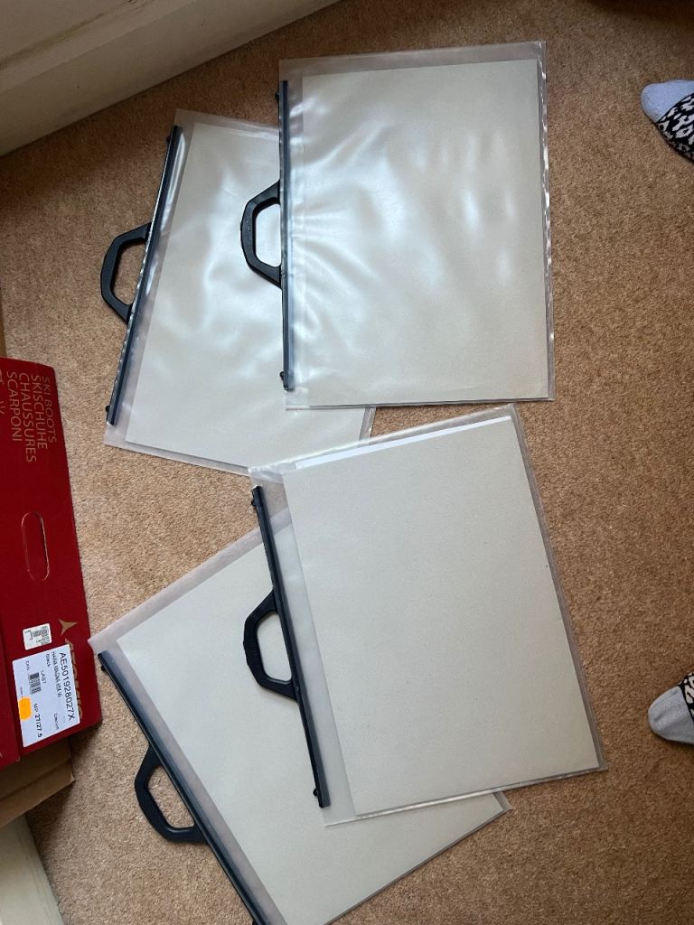 This is a Mapac Polyholdall clear plastic art portfolio case with a black clip-close handle.