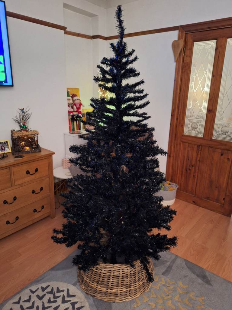 6ft black Christmas tree with wicker skirt 