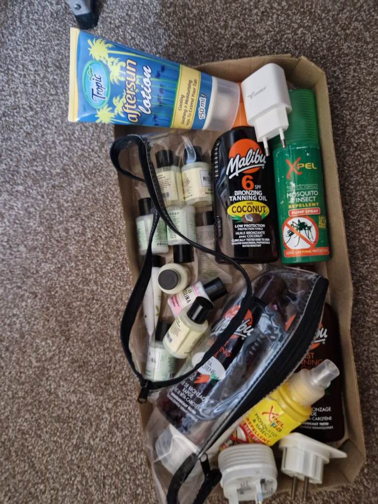 Assortment of sun tan lotions , insect repelkant , body lotions , travel plugs 