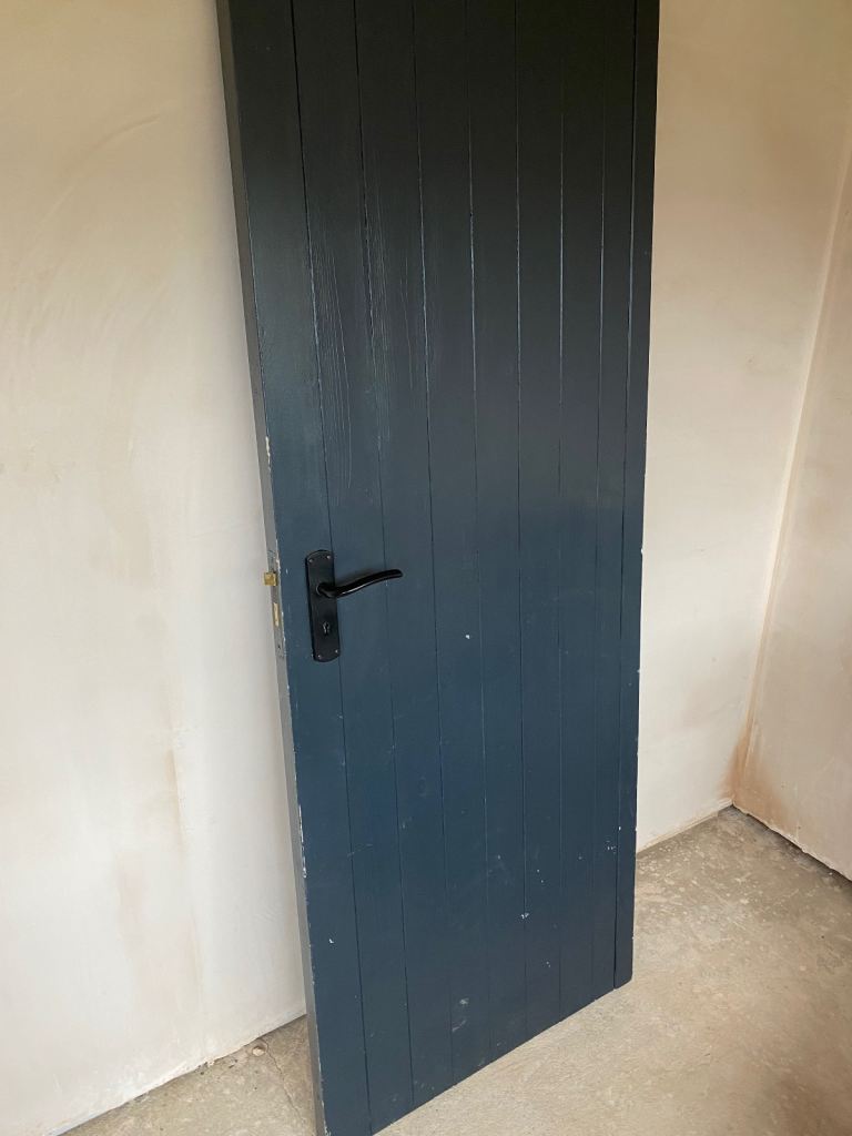 Garage side door with locking handle 