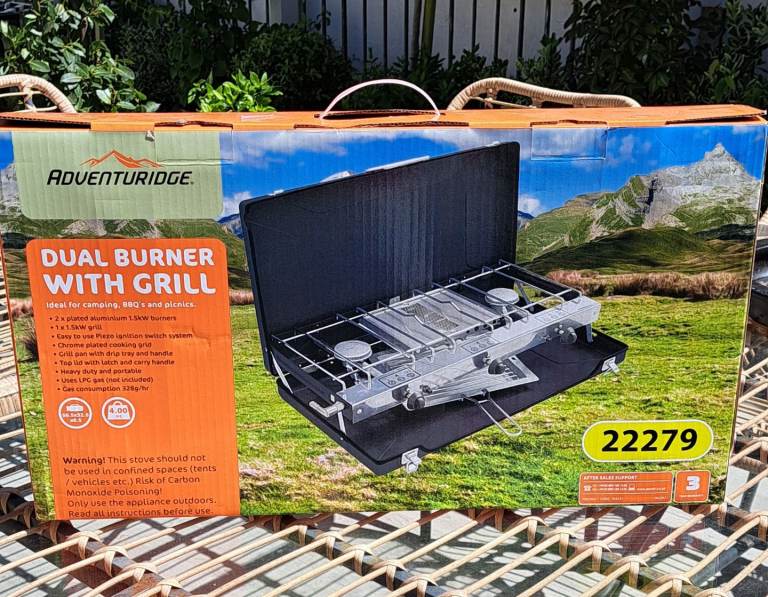 Camping gas burner with grill plus other camping equipment.