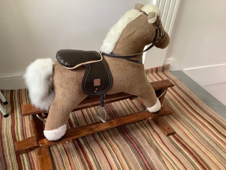 Childs Wooden Rocking Horse with leather saddle and metal stirrups.