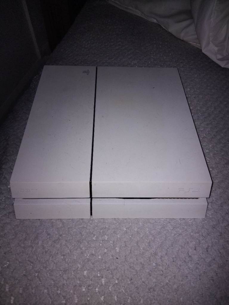 White PlayStation 4 with controller 
