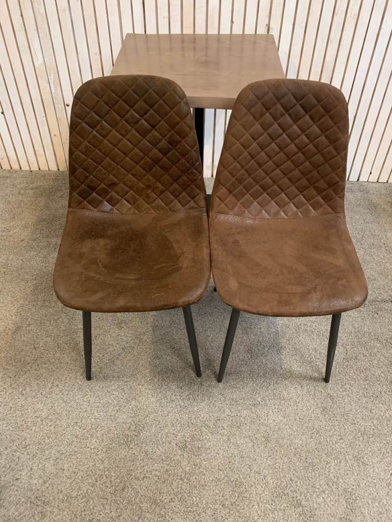 Bistro Dining Table with two Chairs, featuring Square Brown Faux-Suede Seats .