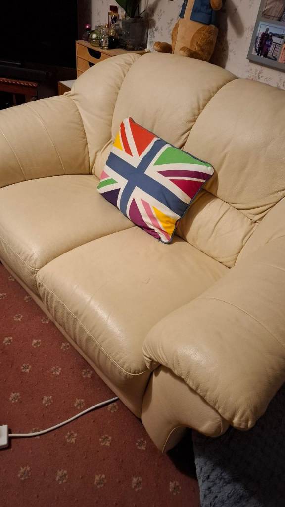 Two seater white leather sofa. 