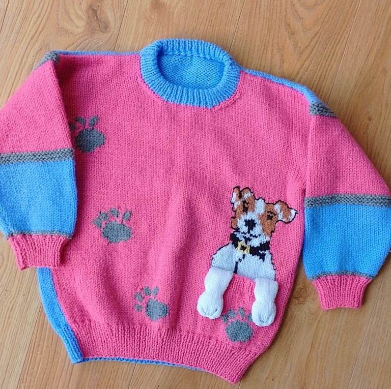 Hand knitted child's round neck woollen jumper with novelty puppy pocket. 40cm across
