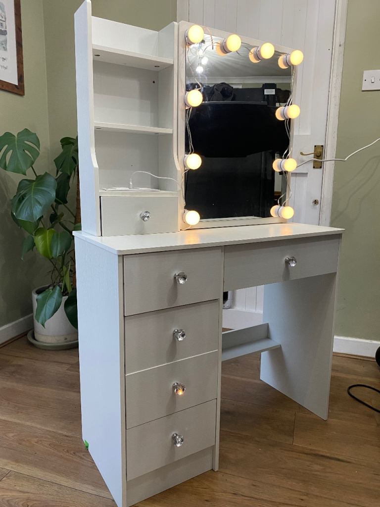 A sliding mirror vanity dressing table
