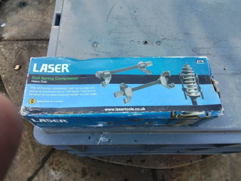 Laser coil spring compressor