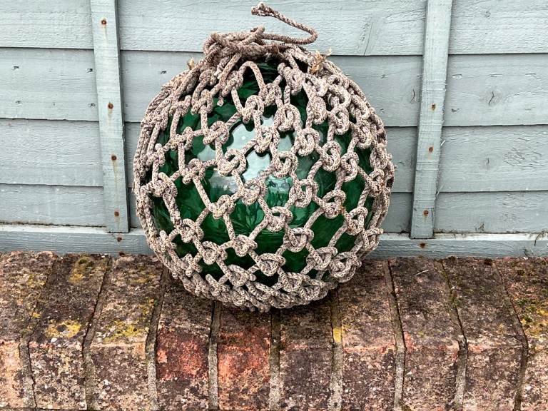 Rare large glass fishing float with rope netting
