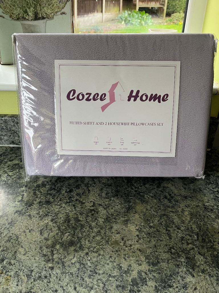A new and unused Cozee Home king set fitted sheet and two pillow cases.