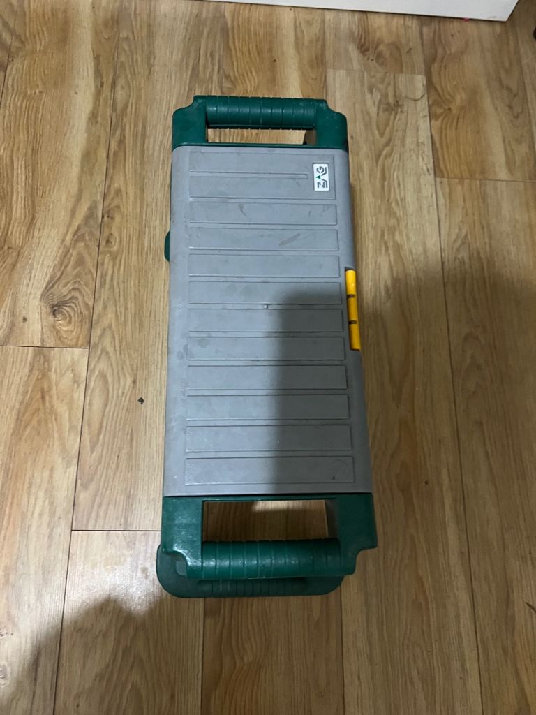  A sturdy green garden stool with a handy storage