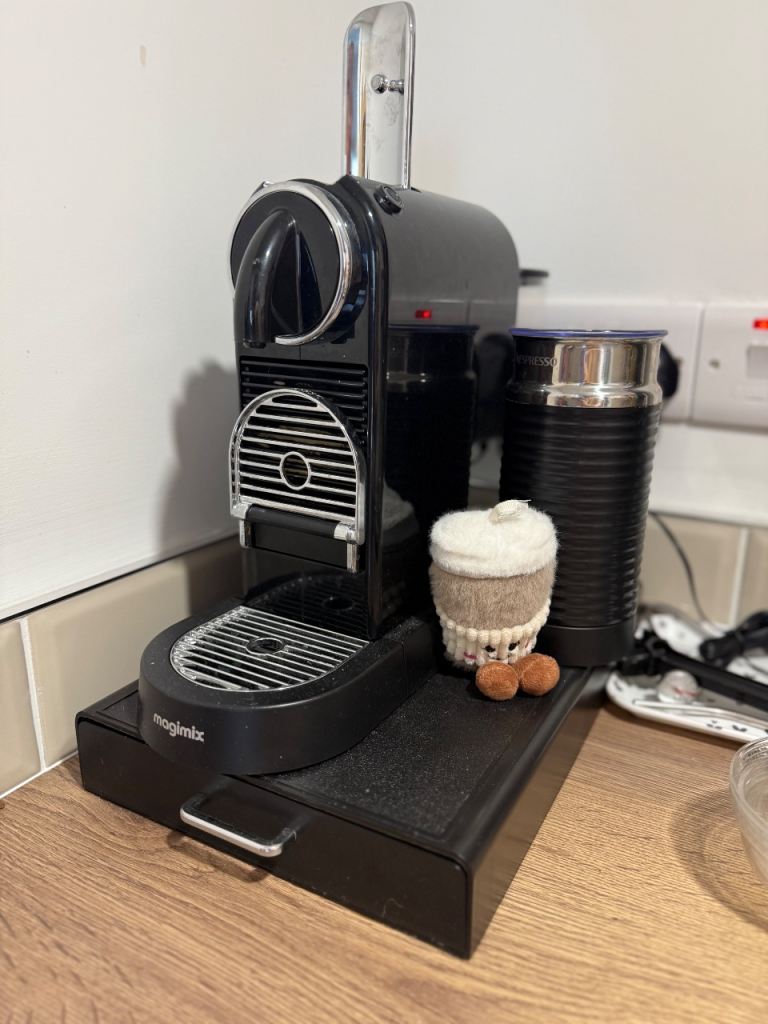 Nespresso coffee machine with milk frother attached 