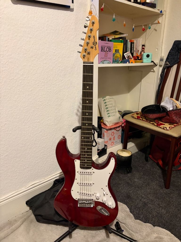 Electric guitar with amp, stand, bag, and cord assistance 
