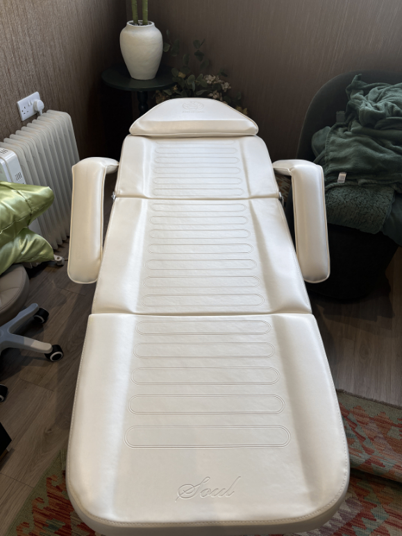 Adjustable white massage table