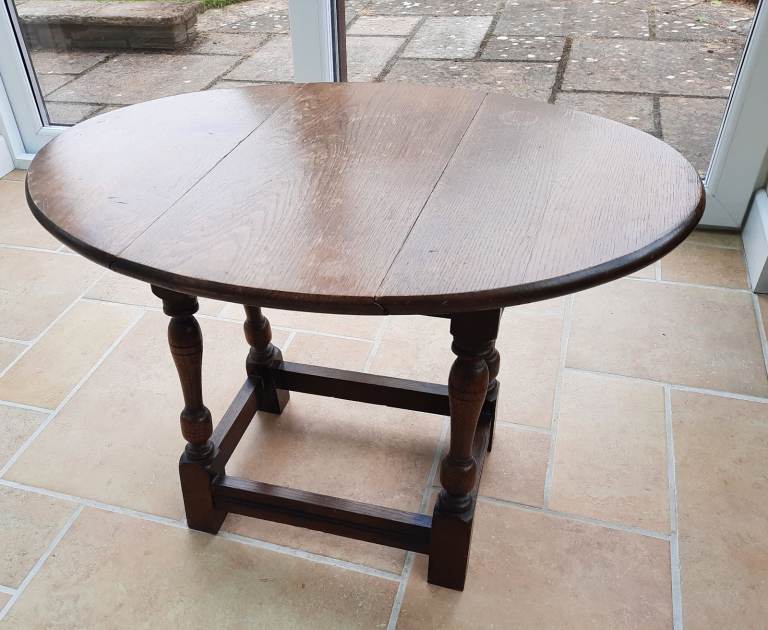 Drop leaf solid oak small coffee table with attractive legs. Collection only.
