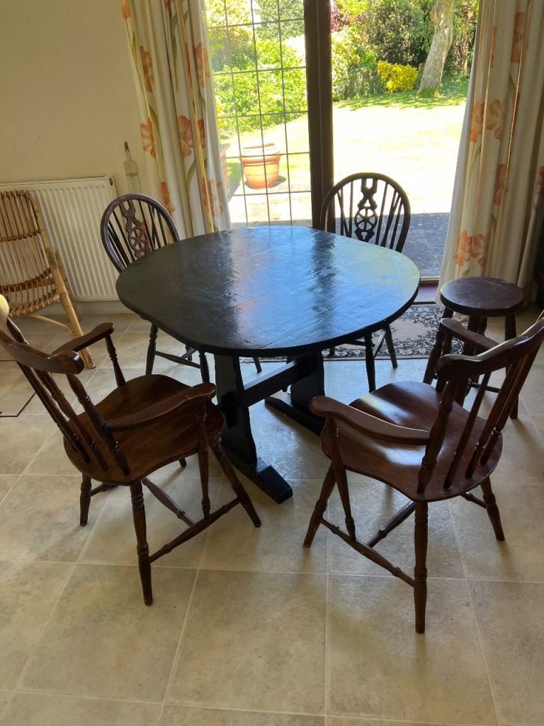 Dark brown vanished kitchen table and assorted chairs