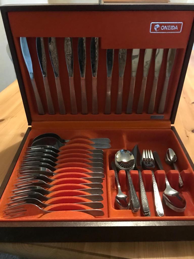 Vintage Oneida stainless steel cutlery canteen in a decorative presentation box.