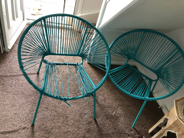 Two blue synthetic rattan egg chairs for garden or room
