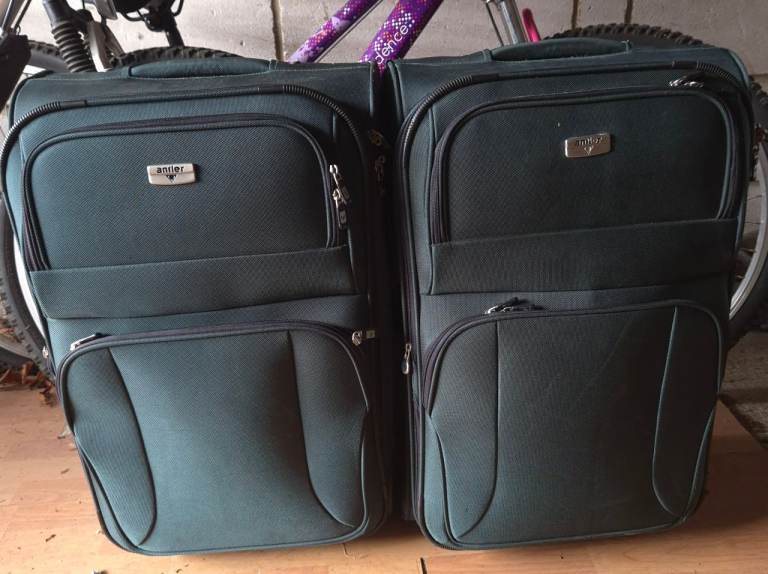 2 x Antler softshell suitcases featuring a dark green fabric exterior
