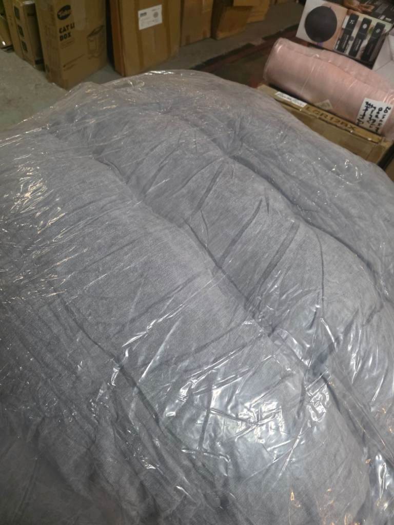 A large grey fabric fod bed /pad . 
