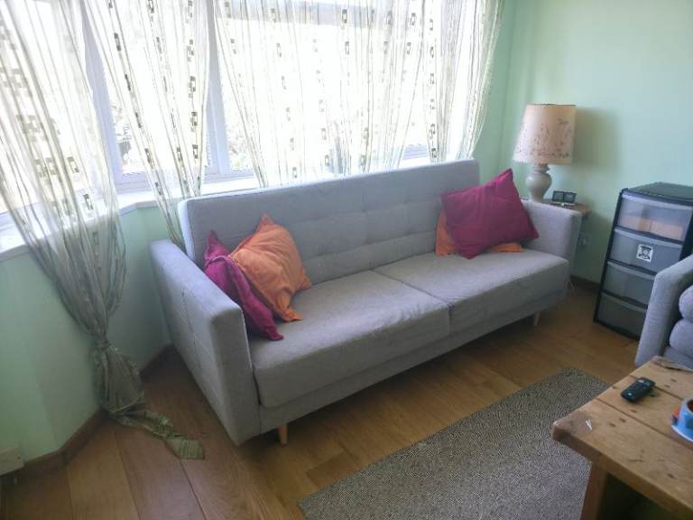 Blue fabric sofa bed with storage, folds flat
