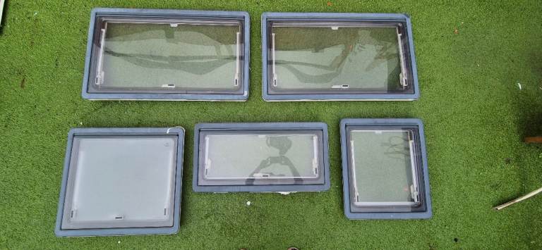 Windows with frames, blinds and flynet for van conversion.