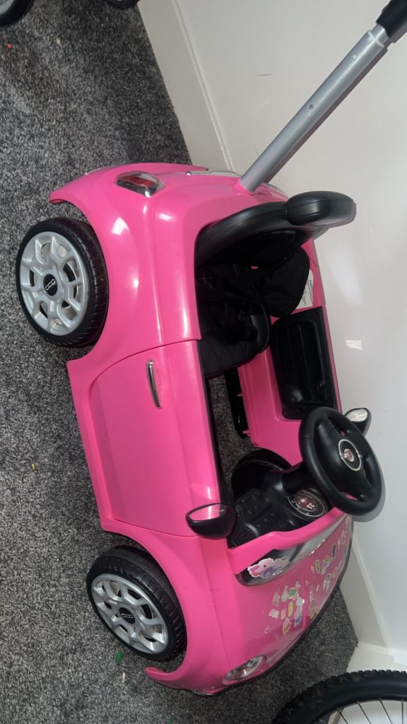 Pink girls push car 