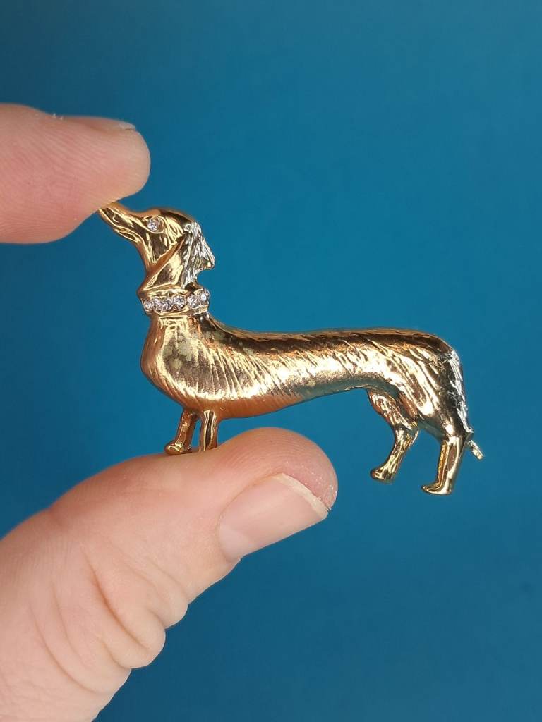 gold-tone dachshund dog brooch with a crystal-studded collar. 
