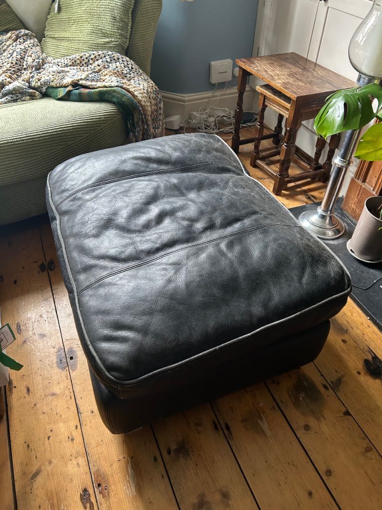 large black leather footstool 